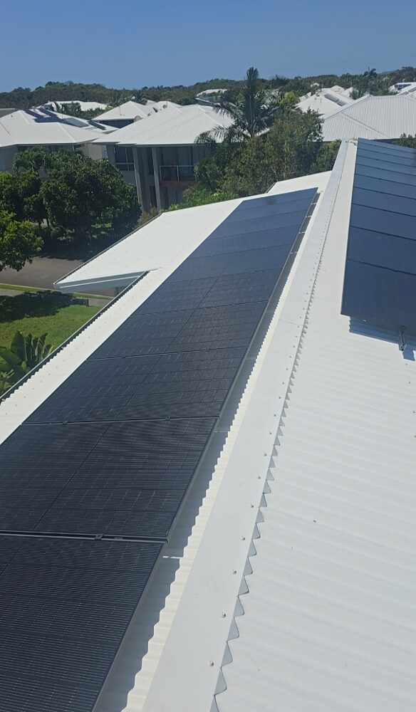 Solar energy technician inspecting rooftop panels